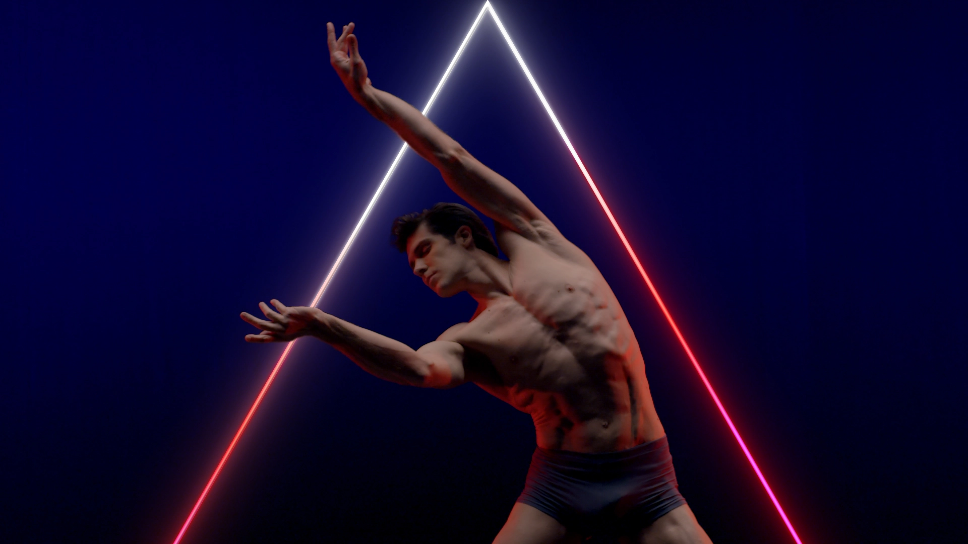 Dancer in motion with moving neon geometric composition